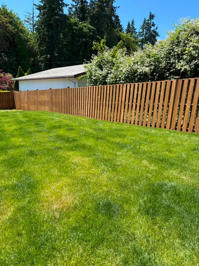 Finished wide lawn fence run with final stain color