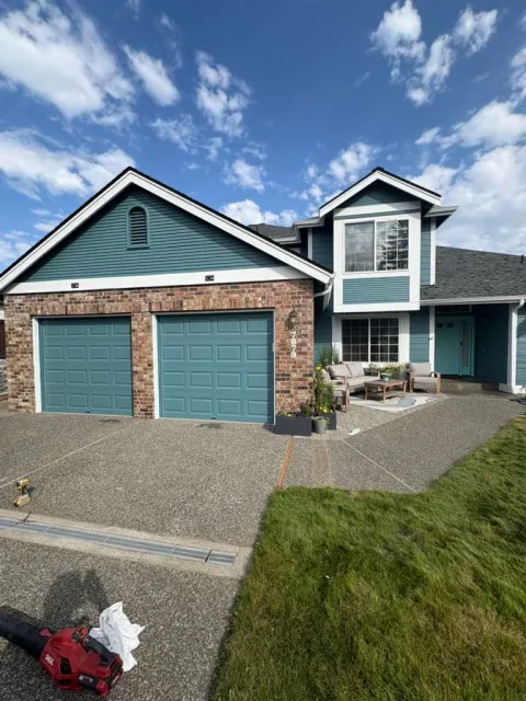 Finished blue front elevation with painted garage doors and white trim