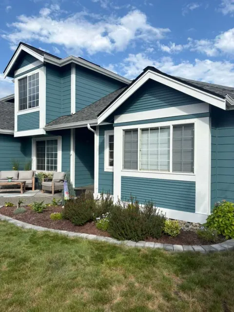 Finished blue gable and exterior siding with crisp white trim