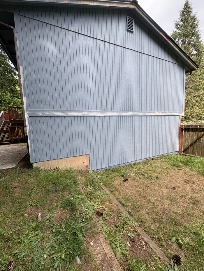 Gray primer coat completed on side exterior siding during a Kitsap County repaint