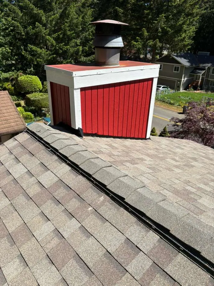 Small outbuilding painted red with white trim to match the main house